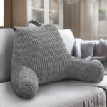 Gray textured backrest pillow on a sofa in a cozy living room.