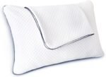 A white contoured pillow with a diamond-quilted texture and dark blue piping along the edges, shown on a plain white background.