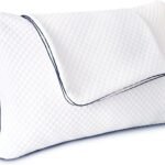 A white contoured pillow with a diamond-quilted texture and dark blue piping along the edges, shown on a plain white background.